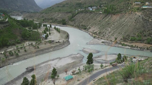 Confluence of Chandra and Bhaga rivers gives birth to Chenab river in Tandi, Lahaul and Spiti district, India. Beautiful landscape view of confluence of Himalayan rivers in Lahaul during summer day.