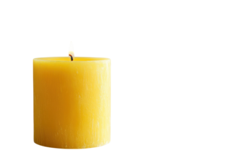 A soft glow of a solitary yellow candle illuminating a calm space in late afternoon light
