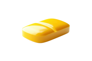 Bright yellow bar of soap resting on a clean white surface, embodying simplicity and freshness