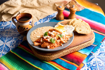 Mexican traditional chilaquiles breakfast red salsa