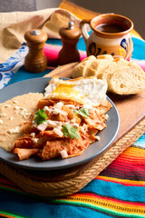 Traditional Mexican chilaquiles with red sauce, authentic mexican breakfast