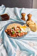 Delicious chilaquiles with fried egg and refried beans for authentic mexican breakfast