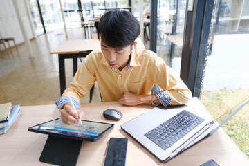 Student studying online and preparing for exams with digital devices and books
