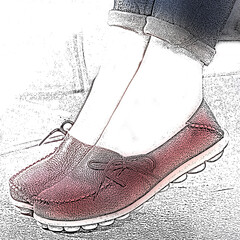 Loafers with textured leather are showcased on a pair of feet. The shoes are a rich reddish-brown, featuring decorative laces and a stitched design along the edges.