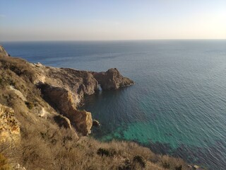 Coastal View of Rocky Shoreline Under Clear Sky  