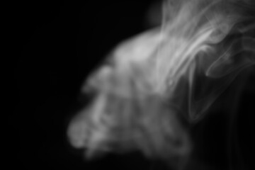 Ethereal Wisps of Smoke Dancing in a Dark Background