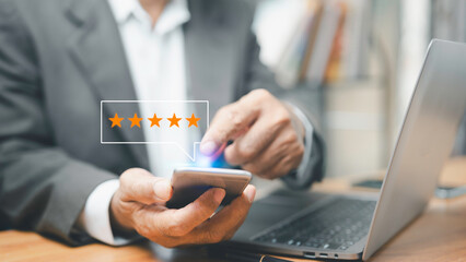 Man using smartphone to give 5 star satisfaction, concept of appreciation of service, comment,...