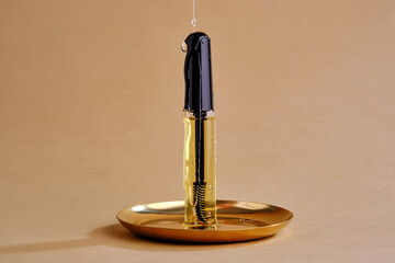 Bottle with brush filled with oil for eyebrow and eyelash growth. Texture.