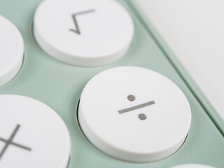 division symbol key on a calculator, performing division operations.