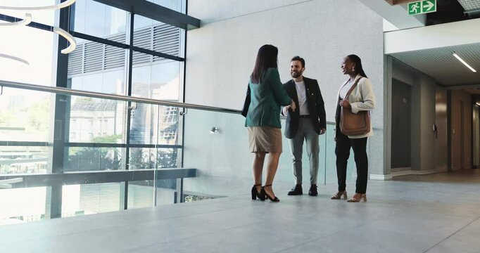 Business, people and handshake in lobby for meeting, welcome or introduction to company. Corporate team, woman investor or shaking hands in office building for walkthrough, thank you or collaboration