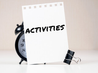 activities header on white note paper background alarm clock