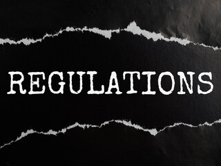 regulations text title on black torn paper background