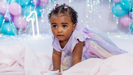 Beautiful baby, black girl, dressed as a princess celebrating her 1st birthday on a beautiful...