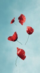 Floating red petals against the sky