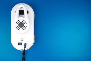 A modern carbon monoxide detector is beautifully mounted on a vibrant blue wall, ensuring both safety and style