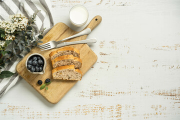 Full breakfast board with toast, milk and flowers.