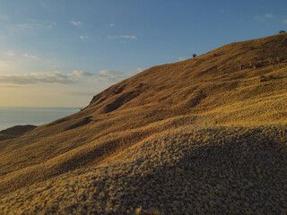 Gili Lawa, Indonesia - 6 Feb 2024: Visitor trackinh and hiking hills at Gili Lawa Darat Island Sunset in Komodo National Park