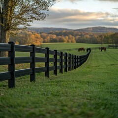 Obraz premium Scenic Pasture with Horses and Black Fence in Autumn Landscape