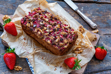 Baked dates and rolled oats loaf with strawberries and walnuts