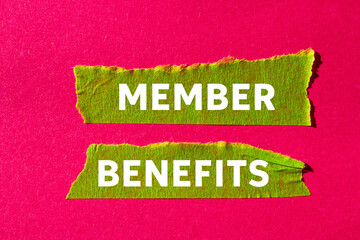 Member benefits message written on ripped torn green paper tape on pink background. Conceptual member benefits symbol. Copy space.