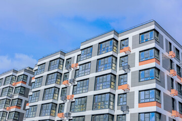 A stunning architectural view showcasing a modern multifamily apartment building set against a...