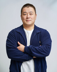 Man with crossed arms in a navy jacket