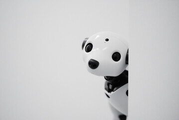 robot dog peeking around the corner of a white wall, mimicking curiosity. copy space