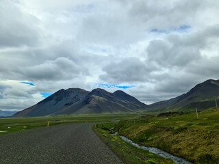 Fototapeta premium Scenic road winding through Iceland's majestic mountains and vast plains