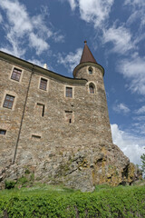 Velhartice Castle with its stone tower and walls against a blue sky with white clouds. Historic medieval fortress in the Czech Republic © Marcel