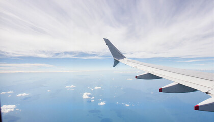 Obraz premium Streamlined airplane wing soaring through clouds, efficiency in flight