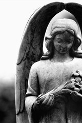 Spiritual angel serving God as a guardian of human beings. Black and white vertical image.