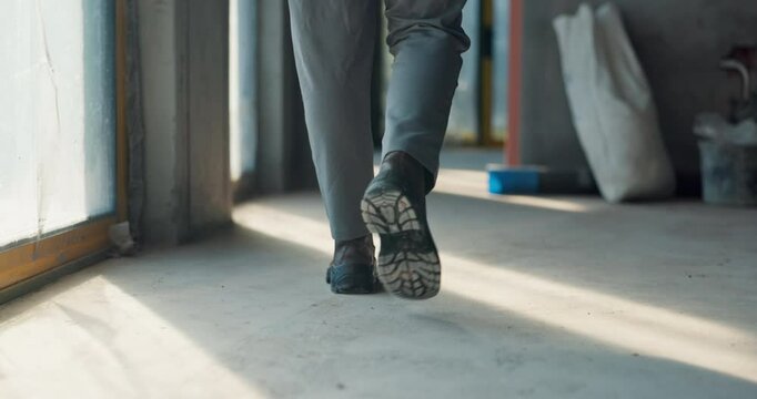 Construction, worker and legs of person walking for project, development and evaluation of progress. Contractor, boots and feet on floor in building for civil engineering, inspection and renovation