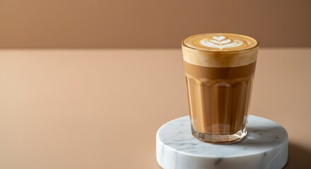 Latte with heart art on marble coaster against beige background