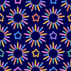 Seamless pattern of colorful pencils arranged in circular flowers and  stars on a dark blue background.