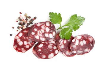 Pieces of delicious dry cured sausage and spices isolated on white, top view