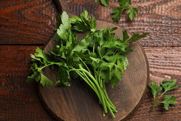 Fresh parsley on wooden table, top view