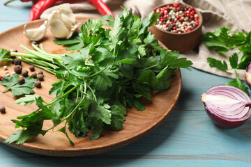 Fresh parsley and spices on blue wooden table, closeup