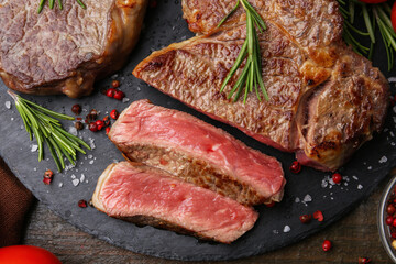 Pieces of delicious beef meat and spices on table, top view