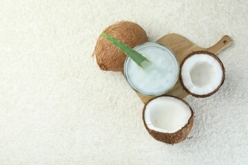 Refreshing drink with coconut and aloe on white textured table, flat lay. Space for text