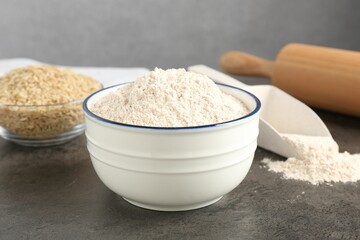 Brown rice and flour on grey table, closeup