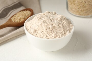 Brown rice and flour on white table, closeup