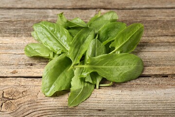 Fresh green sorrel leaves on wooden table, closeup
