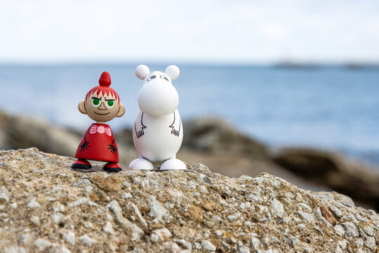 Tallinn, Estonia. September 1st, 2024.  Wooden figures of Little My and Moomin character from Tove Jansson books sitting by the sea. Artistic wooden toys of  finnish literature characters  
