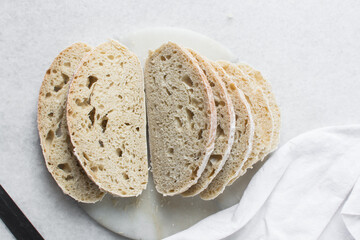 Overhead view of sliced homemade artisan bread, top view of baked sourdough artisan bread slices