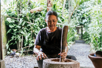 Traditional cooking coffee in lush garden setting of Bali