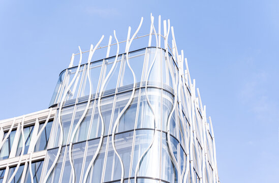 Fototapeta Modern architectural facade with sleek, flowing metal design