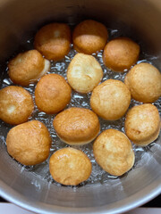 Golden Brown Puff Balls Cooked in Hot Oil to Perfection for All to Enjoy as a Treat