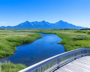 Serene river view with mountains under clear blue sky, seen from a wooden bridge