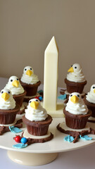 "Patriotic bird sanctuary cupcakes feature eagle toppers and nest frosting on branch stands surrounding a white chocolate monument centerpiece."