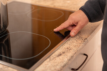 Touchscreen control on modern induction stove top in kitchen